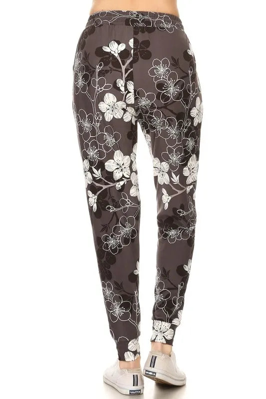 Back view of buttery soft floral joggers featuring a stylish floral design in black and white