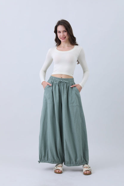 Light green boho linen pants for women with a relaxed fit and side pockets from Leto Collection