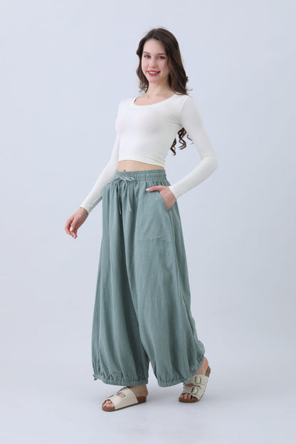 Fashionable boho linen pants for women in light green with an elastic waistband and side pockets