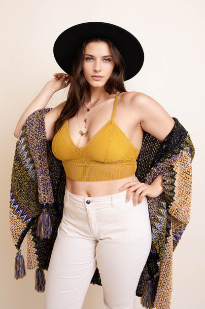Plus size boho bralette in mustard yellow, styled with a black hat and crochet shawl