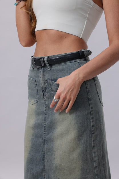 Woman wearing a gray denim skirt featuring an antique floral western belt for a stylish boho look
