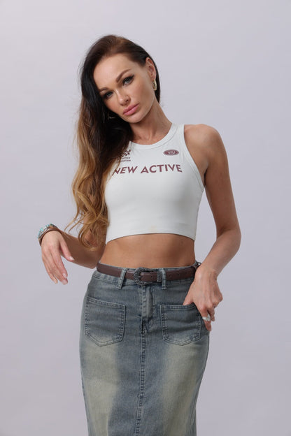 Model wearing an antique floral western belt with a stylish outfit featuring a crop top and denim skirt