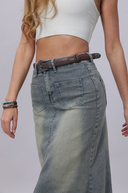 Model wearing a denim skirt with an antique floral western belt to enhance the boho style