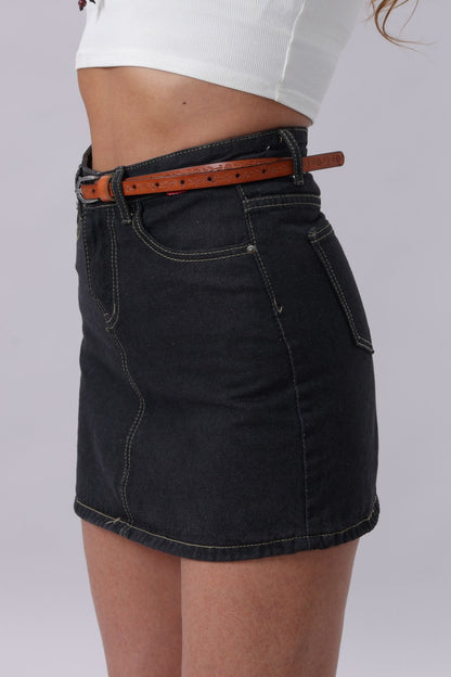 Floral embossed skinny leather belt worn with a black denim skirt for a stylish boho look