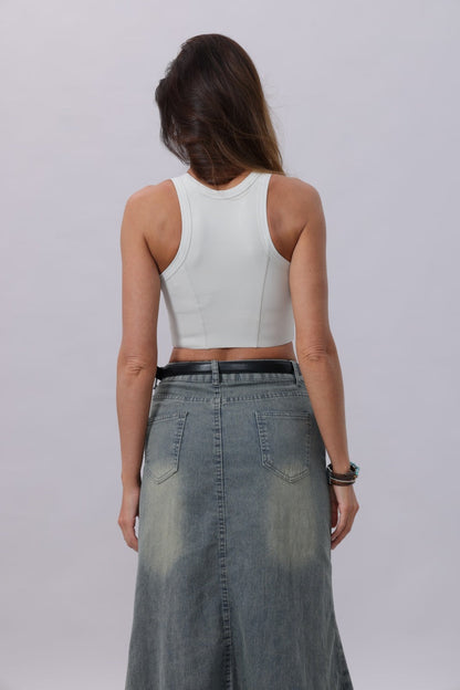 Woman wearing a white crop top and denim skirt with a classic silver buckle belt women for a stylish look