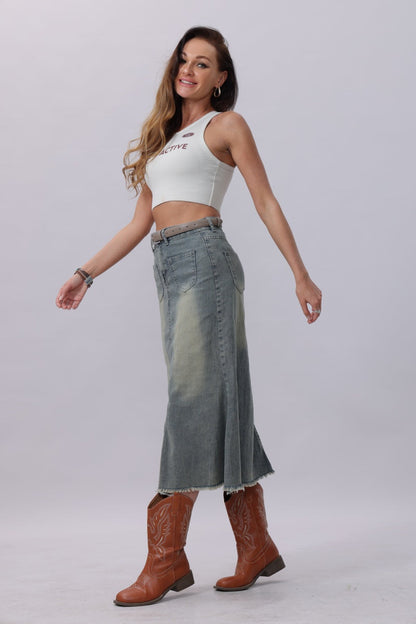 Classic silver buckle belt women paired with a stylish outfit featuring a denim skirt and cowboy boots