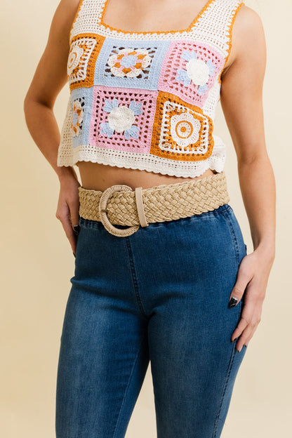 Leto Collection boho woven raffia belt styled with a colorful crochet crop top and denim jeans