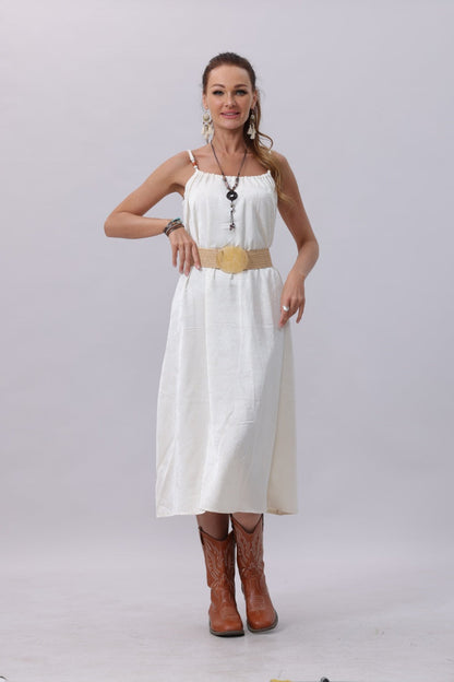 Model wearing a white dress with a boho woven belt with buckle and stylish brown boots