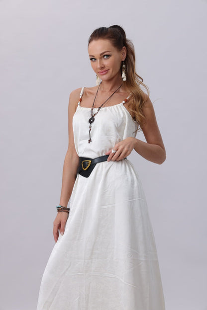Fashion model wearing a boho wide waist belt with a white maxi dress for a chic summer look
