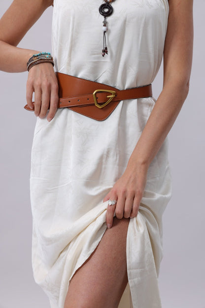 Boho wide waist belt in brown leather worn over a white dress for a stylish look