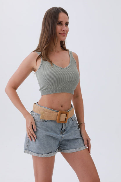 Model wearing a boho woven raffia belt styled with denim shorts and a crop top