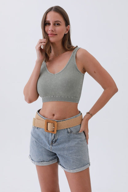 Model wearing a boho woven raffia belt styled with a cropped top and denim shorts