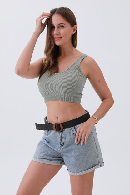 Woman modeling a minimalist boho raffia belt with high-waisted denim shorts and a cropped top