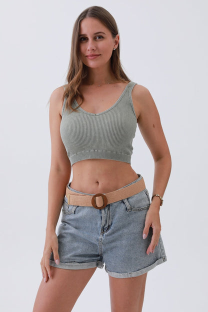 Woman wearing a minimalist boho raffia belt with denim shorts and a cropped top