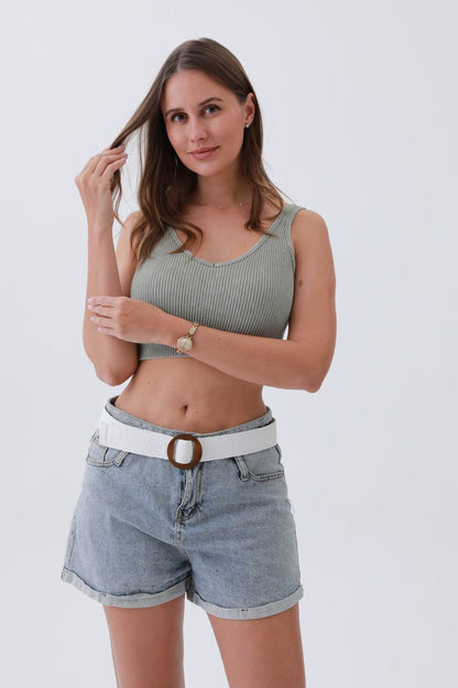 Model wearing a minimalist boho raffia belt with denim shorts and a trendy top