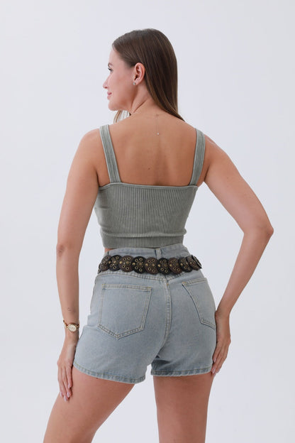 Back view of a woman wearing a boho western belt for women with a casual outfit and denim shorts