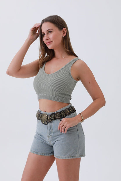 Stylish woman wearing a boho western belt for women paired with a cropped top and denim shorts