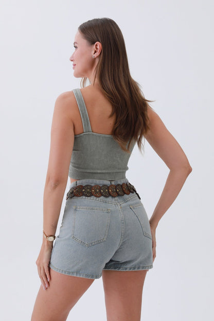 Stylish woman wearing a boho western belt for women with denim shorts and a fitted top
