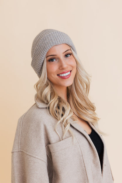 Stylish model wearing an eco friendly knit beanie in light gray for a cozy look