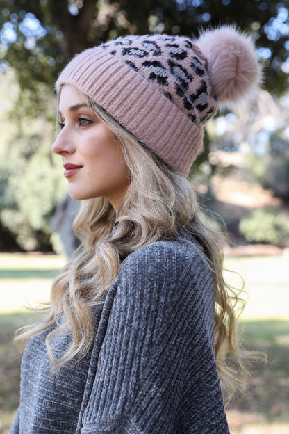 Leto Collection leopard knit beanie in light pink with a fluffy pom pom on top, perfect for winter fashion