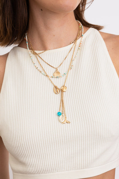 Leto Collection Boho Necklace featuring layered gold chains and shells, perfect for boho chic jewelry and spiritual style