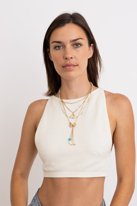 Leto Collection model wearing layered gold Boho Necklace, Boho Chic Jewelry, Spiritual crescent moon pendant with turquoise bead