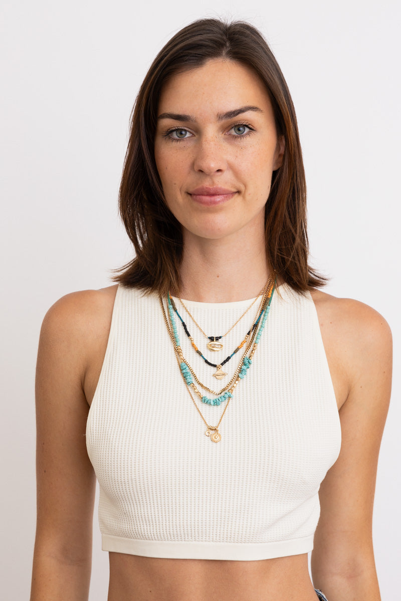 Layered turquoise and gold pendant necklaces on model in white crop top Boho Necklace, Boho Chic Jewelry, Spiritual