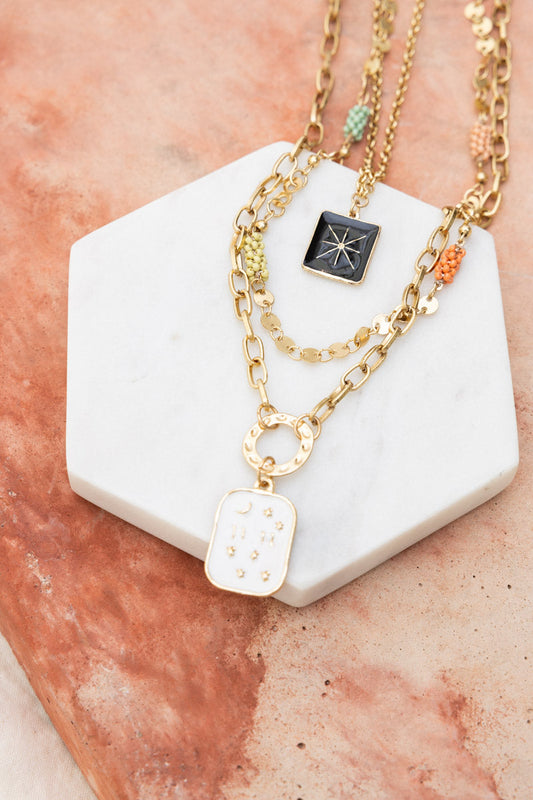 Leto Collection layered gold necklaces on marble display Boho Necklace, Boho Chic Jewelry, Spiritual with star and enamel pendants