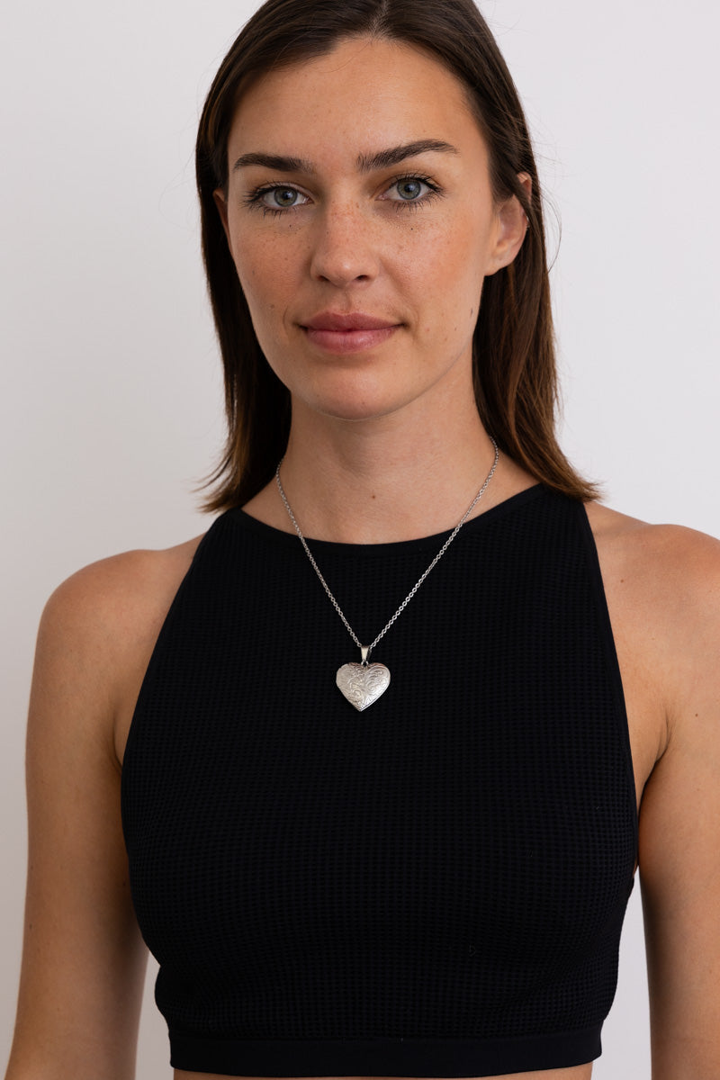 Boho Necklace, Boho Chic Jewelry, Spiritual. Silver heart pendant on chain worn by model over black sleeveless top
