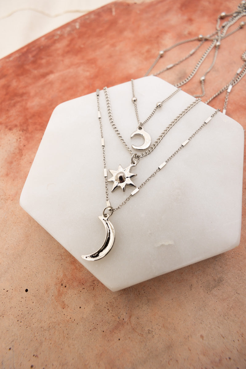Leto Collection layered silver necklaces with moon and sun pendants on white stone Boho Necklace, Boho Chic Jewelry, Spiritual