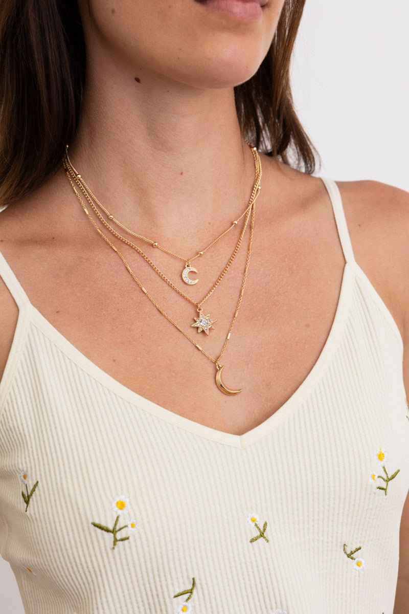 Leto Collection layered gold Boho Necklace, Boho Chic Jewelry, Spiritual crescent and star charms on model in cream tank