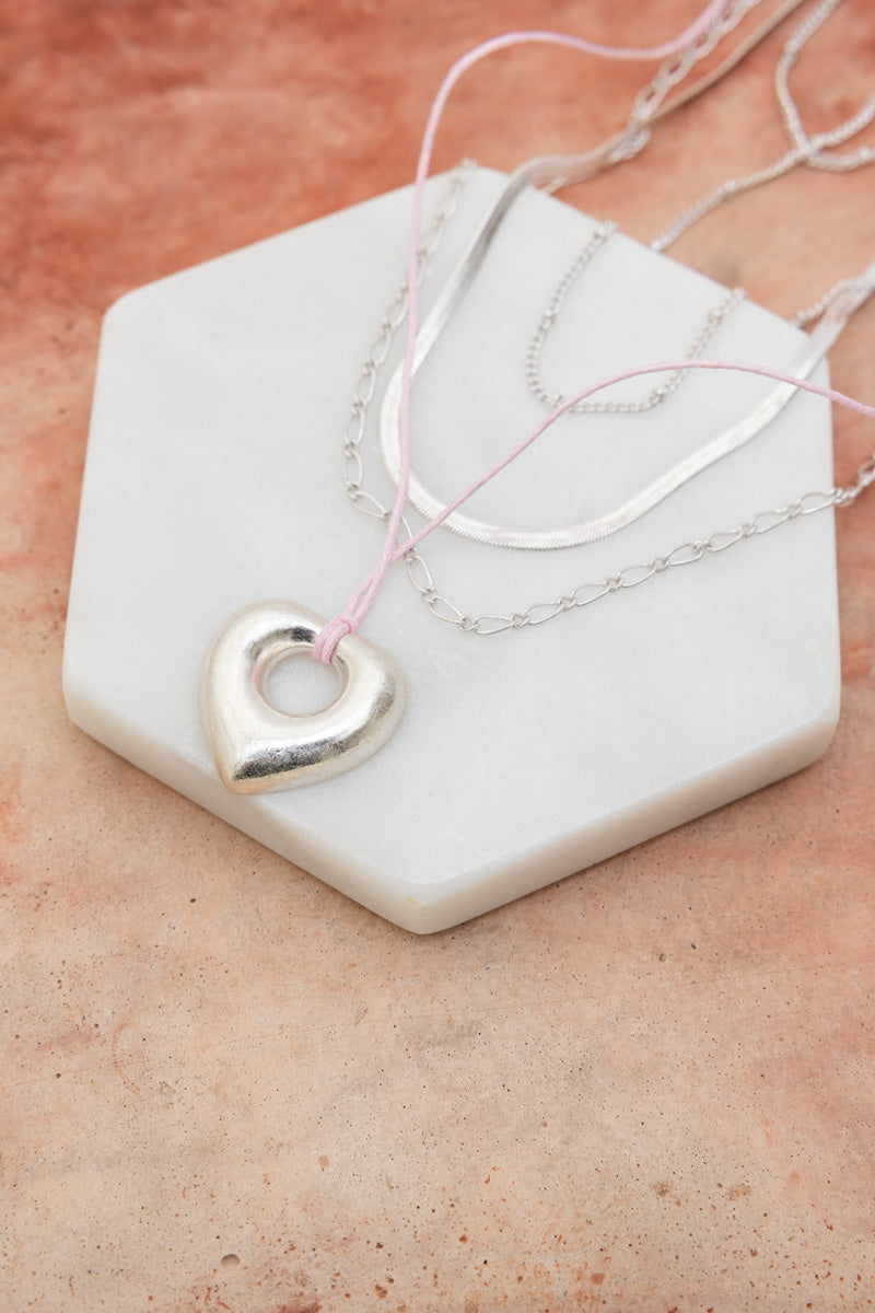 Layered silver chains with heart pendant on pink cord on marble display Boho Necklace, Boho Chic Jewelry, Spiritual