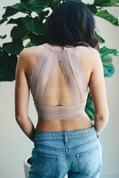 Back view of a Leto Collection boho lace bralette in soft fabric, styled with high-waisted jeans