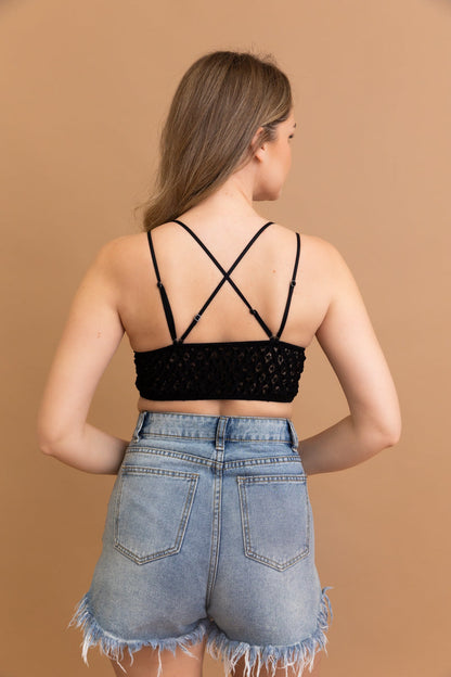 Back view of a stylish boho crochet lace bralette paired with high-waisted denim shorts