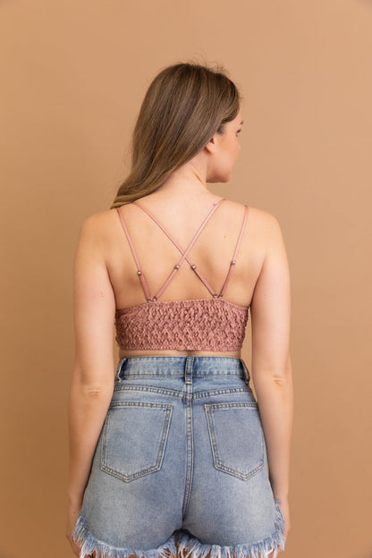 Back view of a woman wearing a Leto Collection boho crochet lace bralette with crisscross straps