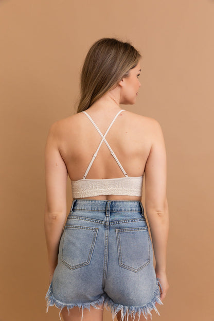 Floral jacquard bralette with crisscross back detail, paired with high-waisted denim shorts