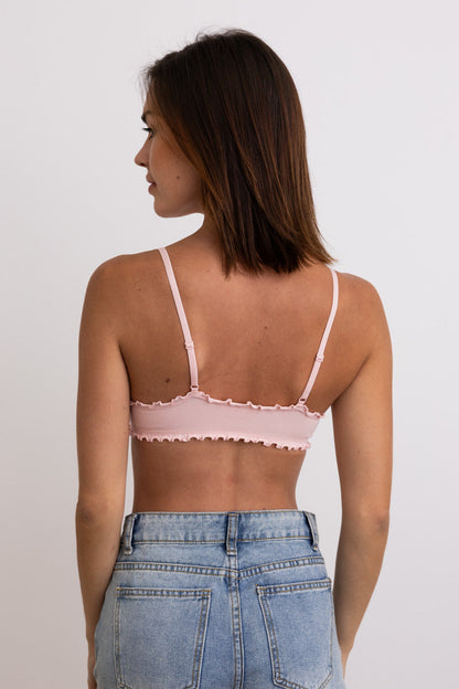 Back view of a pink lettuce edge bralette from Leto Collection with adjustable straps