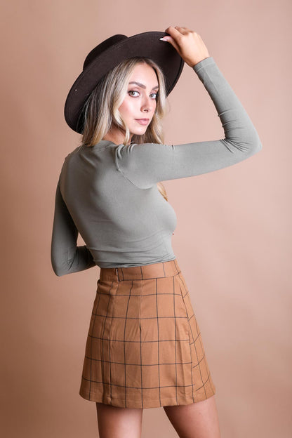 Long sleeve fitted crop top from Leto Collection in olive green, showcasing a close-up of the sleek, stylish design.
