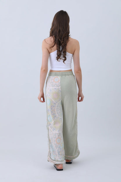 Back view of Leto Collection boho contrast pants for women with a relaxed fit and intricate patterns