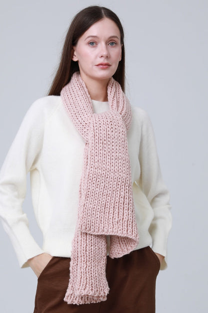 Soft pink chunky ribbed scarf for women styled with a cream sweater for a cozy look