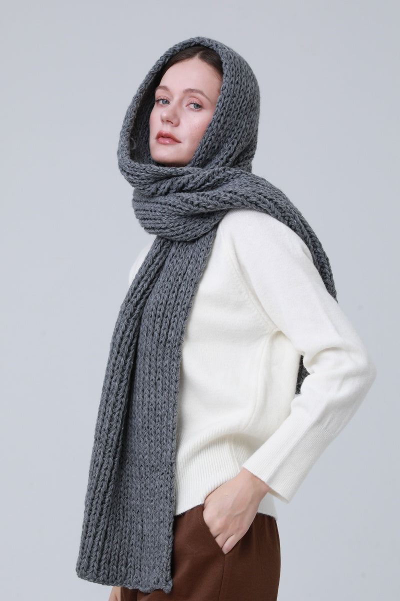 Chunky ribbed scarf for women in gray paired with a cozy white sweater for a stylish winter look