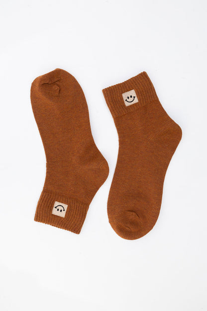 Leto Collection Smiley Face Socks in warm brown color with cheerful smiley logo on cuff