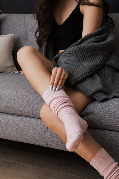 Cozy slouchy knit socks for women in soft pink, perfect for lounging at home