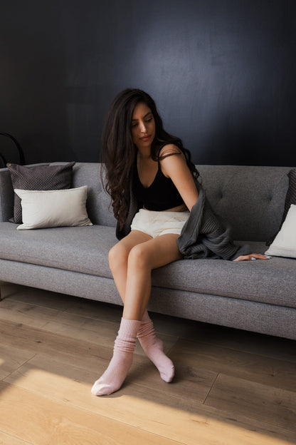 Leto Collection slouchy knit socks for women in soft pink, styled in a cozy living room setting