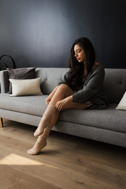 Leto Collection slouchy knit socks for women styled with cozy outfit on a sofa