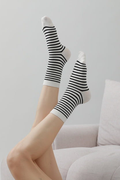 Leto Collection retro striped mid-calf socks displayed with legs raised in a cozy setting