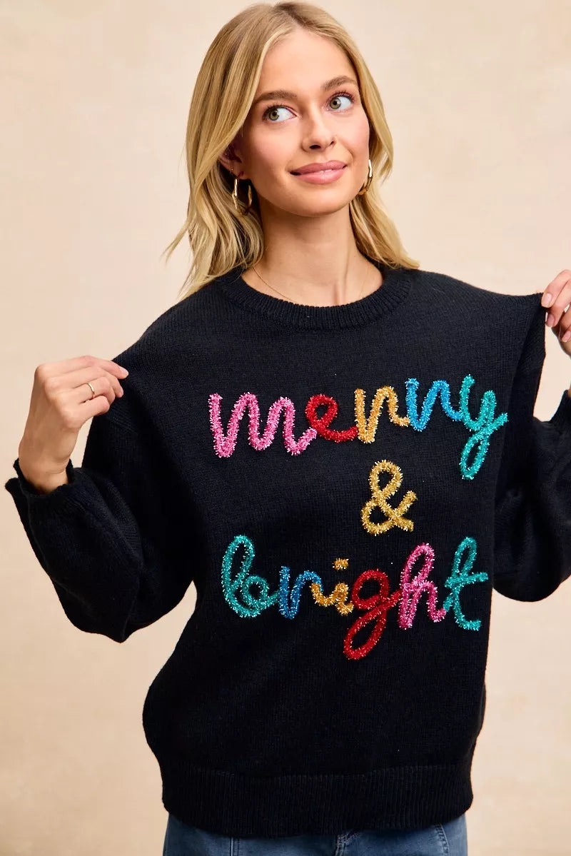 Black tinsel lettering Christmas sweater featuring the words merry and bright for festive holiday wear