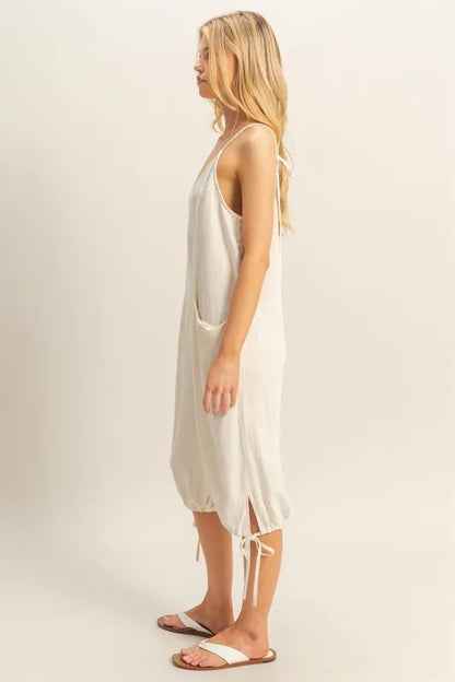Trendsi boho v-neck romper with pockets in neutral color, featuring side ties and a relaxed fit