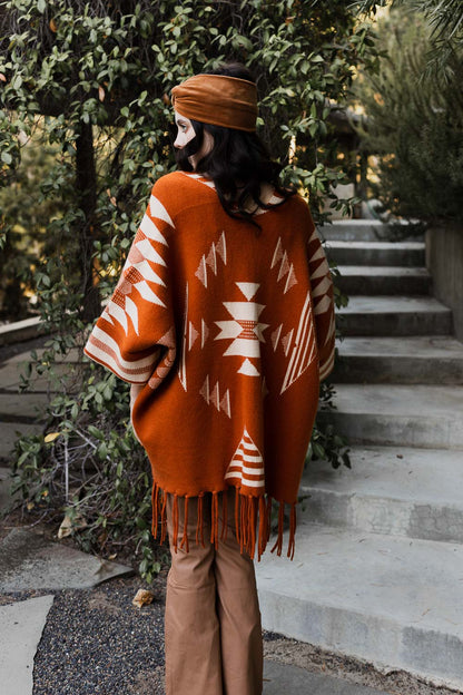 Leto Collection Aztec print fringed ruana in warm orange tones for stylish layering