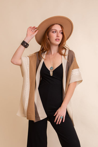 Leto Collection boho knit poncho for women in neutral tones, styled with a wide-brim hat and jewelry